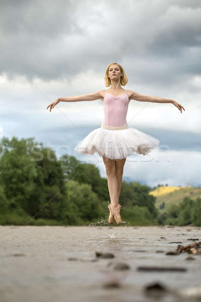 Ballerina jumping above river Stock photo © bezikus