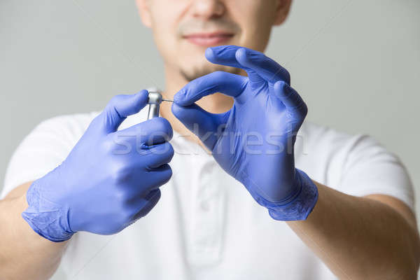 Dentist with dental handpiece Stock photo © bezikus