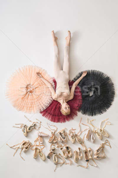 Blonde ballerina lies in studio Stock photo © bezikus