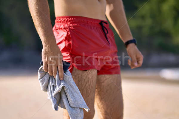 Sportive guy on beach Stock photo © bezikus