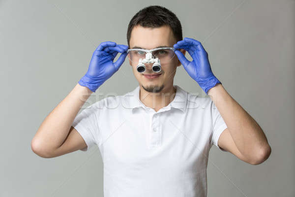 Dentist with binocular loupes Stock photo © bezikus