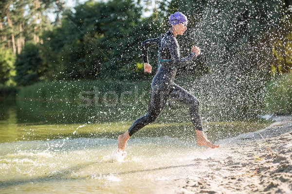 Sportive girl runs on the waterfront Stock photo © bezikus