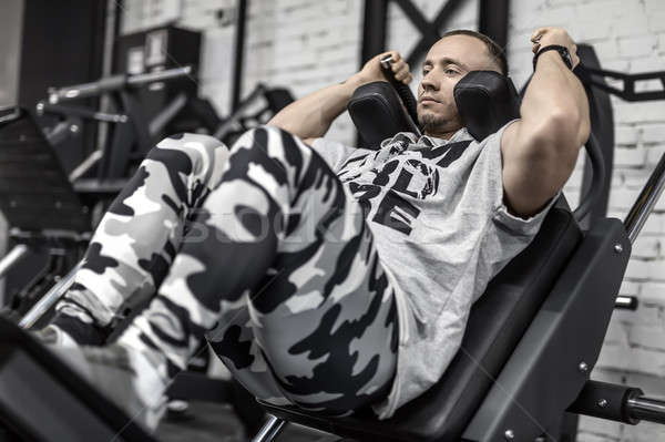 Brutal man's workout in gym Stock photo © bezikus