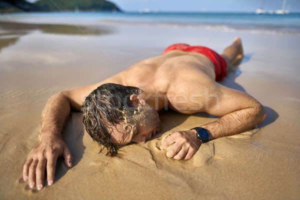 Stock photo: Tanned guy on beach