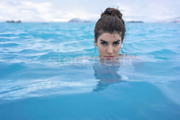 Stock photo: Girl relaxing in geothermal pool outdoors