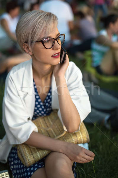 Blonde talks on cell outdoors Stock photo © bezikus