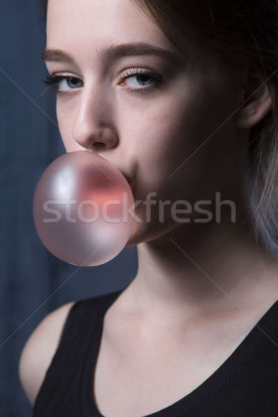 Girl with pink bubble of chewing gum Stock photo © bezikus