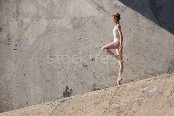 Stock photo: Slim dancer stands in a ballet pose