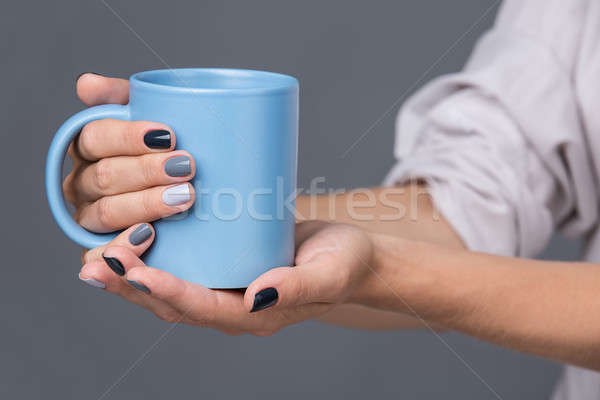 Female hands with blue cup Stock photo © bezikus