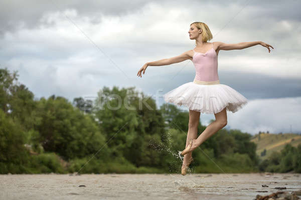 Ballerina jumping above river Stock photo © bezikus