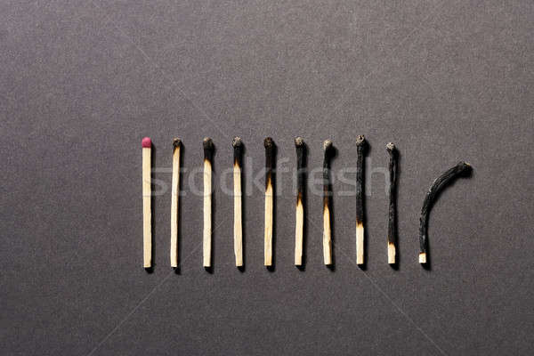 Burnt matchsticks on background in studio Stock photo © bezikus