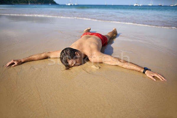 Stock photo: Tanned guy on beach