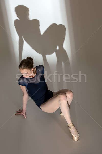 Full-length portrait sitting on the floor of a graceful ballerin Stock photo © bezikus