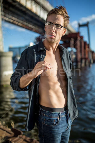 Sigara tiryakisi iskele yakışıklı adam gözlük karanlık Stok fotoğraf © bezikus
