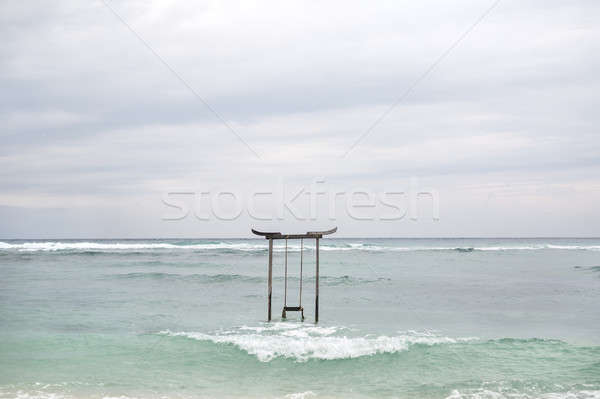 Wooden swing in sea water Stock photo © bezikus