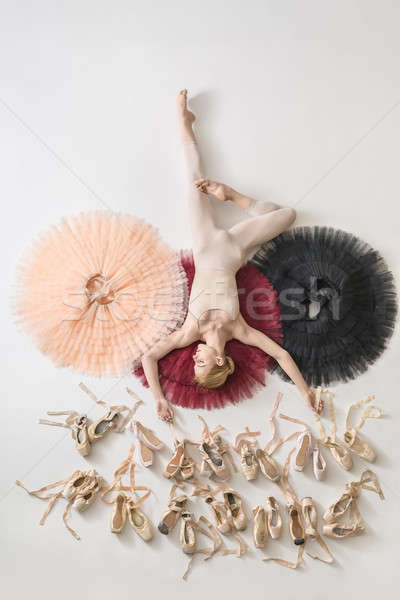 Blonde ballerina lies in studio Stock photo © bezikus