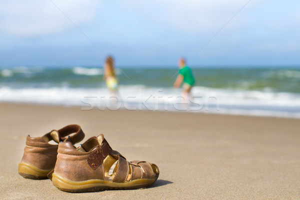 Stock photo: Kid sandals with blurred boy and girl