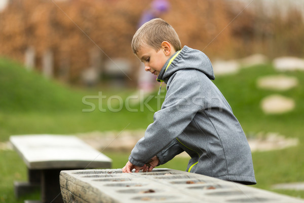 Boy playing mancala with himself Stock photo © bigandt