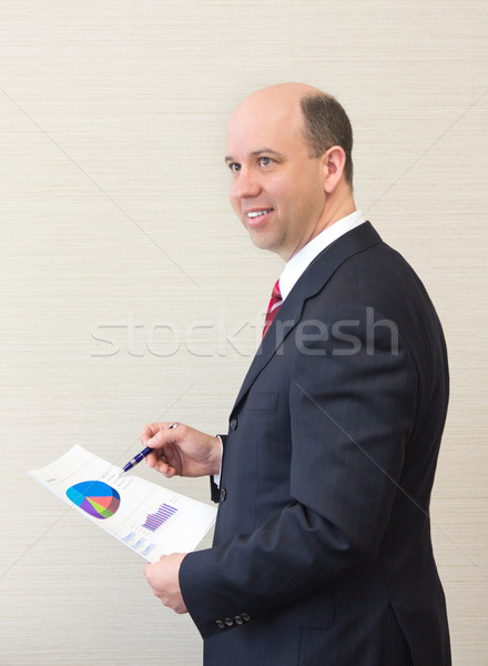 Smiling business man with document. Stock photo © bigjohn36