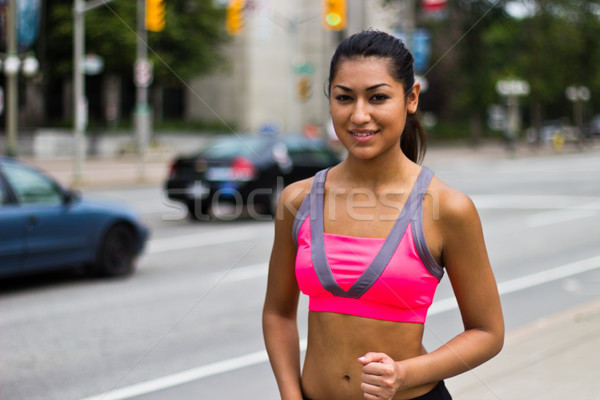 Fit young woman running on a busy city street Stock photo © bigjohn36