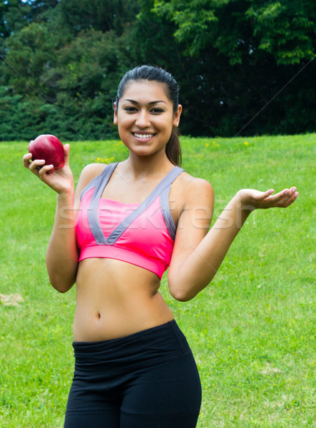 Fit young woman with an apple in the park Stock photo © bigjohn36