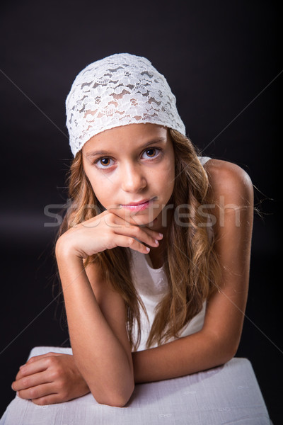 Young girl with white cap on black background Stock photo © BigKnell