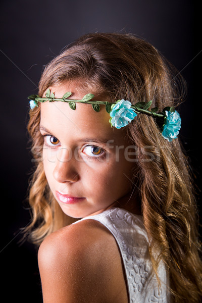 Closeup of a young girl with flower tiara and sober look Stock photo © BigKnell