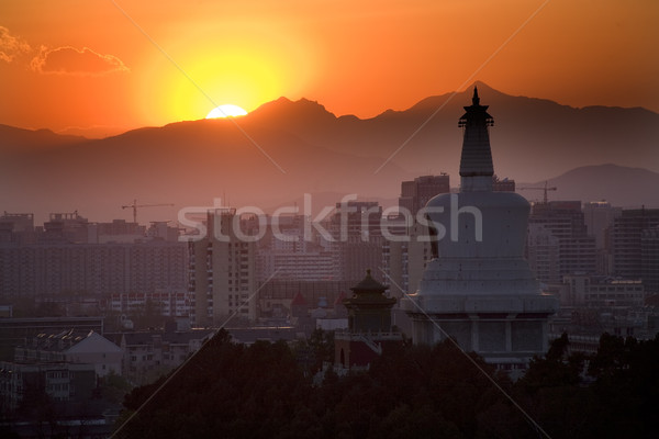 Beihai Stupa with Sunset and Mountains Beijing China Stock photo © billperry