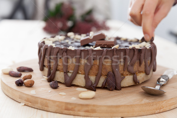 A hand decorating a cake Stock photo © blanaru