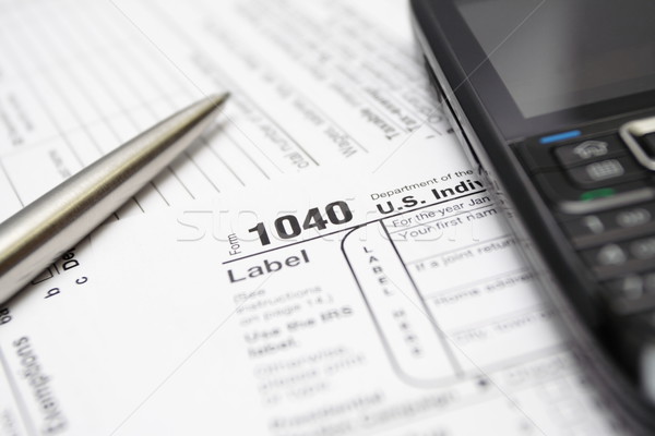 Stock photo: 1040 tax return form smartphone and pen