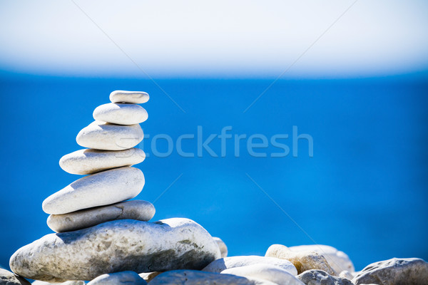 Stones balance, pebbles stack over blue sea in Croatia. Stock photo © blasbike