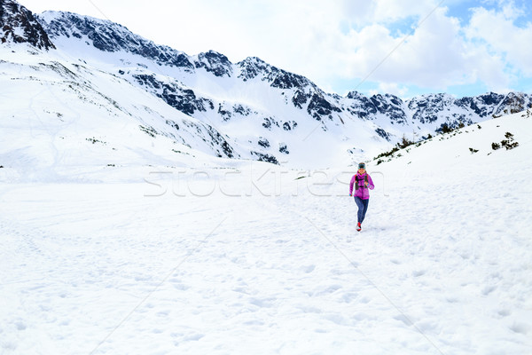 Happy woman running in mountains on winter sunny day Stock photo © blasbike