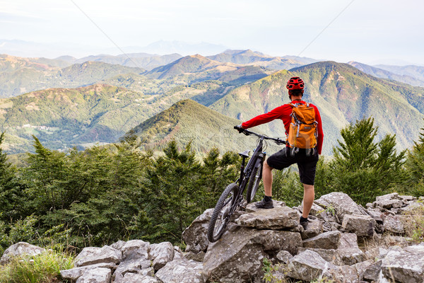 Mountain biker looking at view on bike trail in autumn mountains Stock photo © blasbike