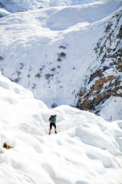 Stock photo: Woman hiking in white winter mountains
