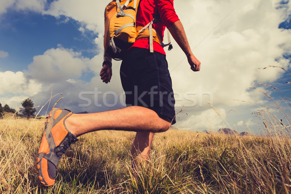 Hiking man with backpack in mountains Stock photo © blasbike