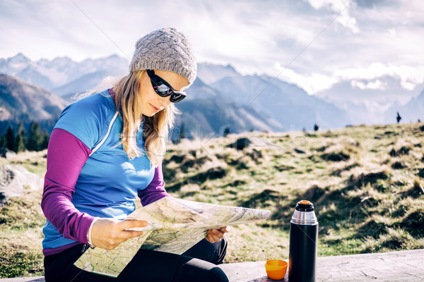 Woman checking map hiking in mountains Stock photo © blasbike