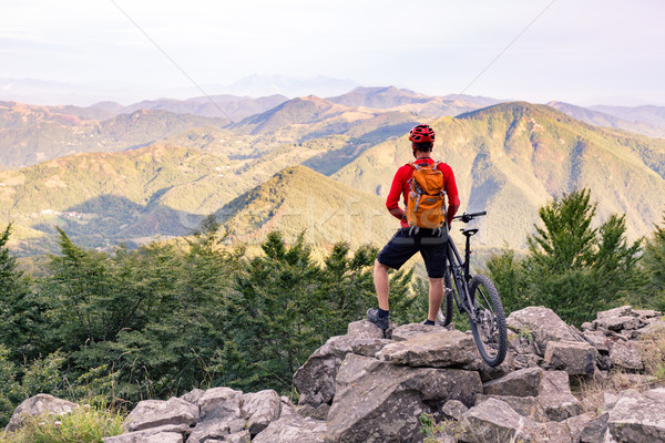 Mountain biker looking at view on bike trail in autumn mountains Stock photo © blasbike
