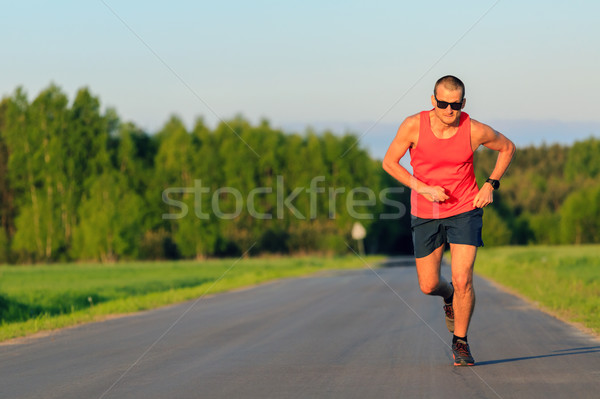 Man running on country road, training inspiration and motivation Stock photo © blasbike
