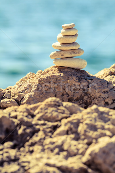 Stones balance at the beach, stack over blue sea Stock photo © blasbike