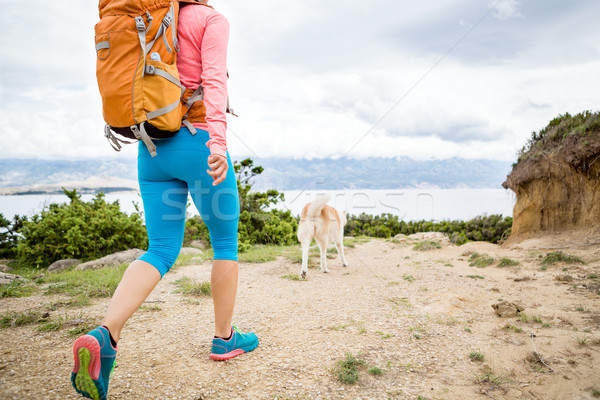 Stock photo: Woman hiking walking with dog on seaside trail