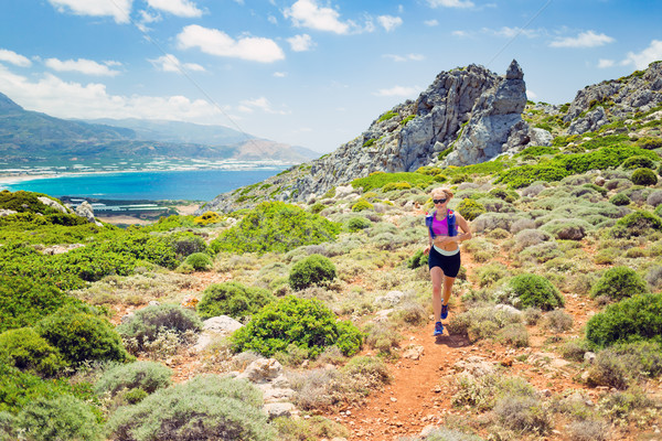 Happy woman trail running in beautiful inspirational landscape Stock photo © blasbike