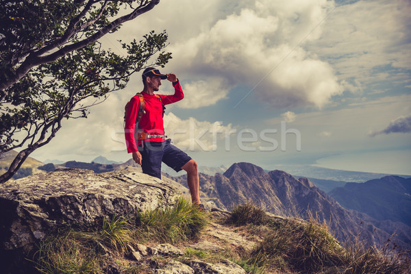 Hiking man or trail runner looking at mountains Stock photo © blasbike