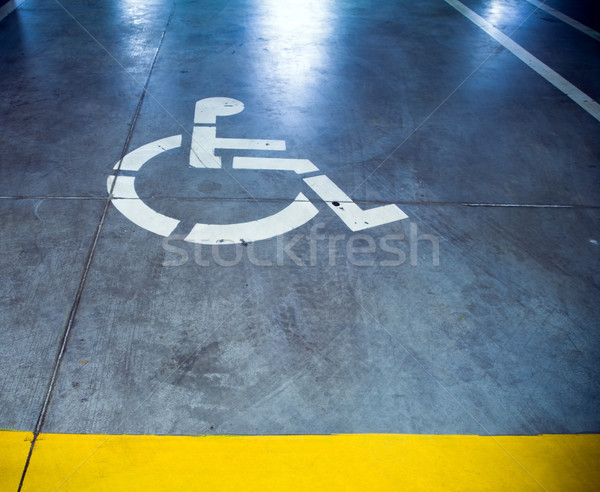 Stock photo: Disability sign in parking garage, underground interior