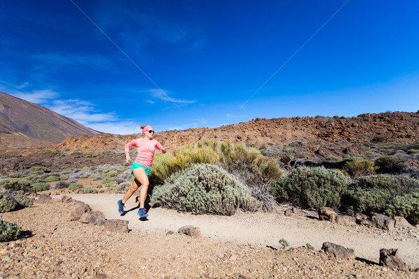 Young woman running in mountains on sunny summer day Stock photo © blasbike