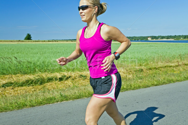 Running woman with music Stock photo © blasbike