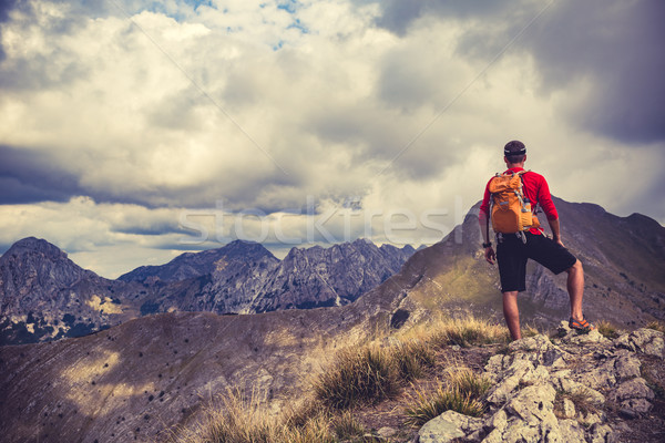 Stock photo: Hiking man or trail runner in mountains