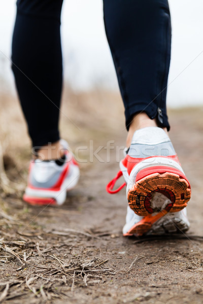 Stock photo: Walking or running legs sport shoes