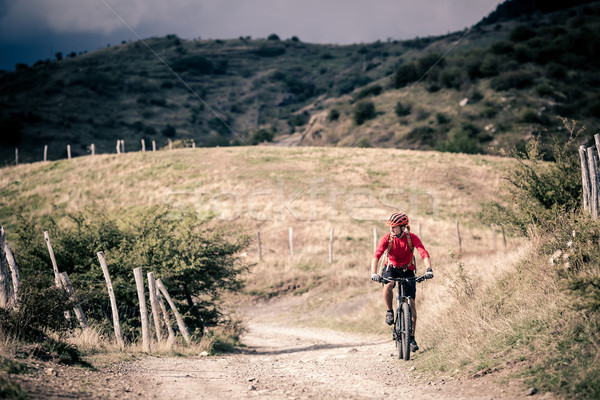 Mountain bike rider on country road, track trail in inspirationa Stock photo © blasbike