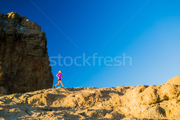 Woman trail running on rocky mountains Stock photo © blasbike