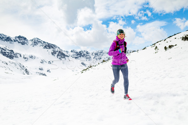 Happy woman winter trail running in beautiful inspirational land Stock photo © blasbike